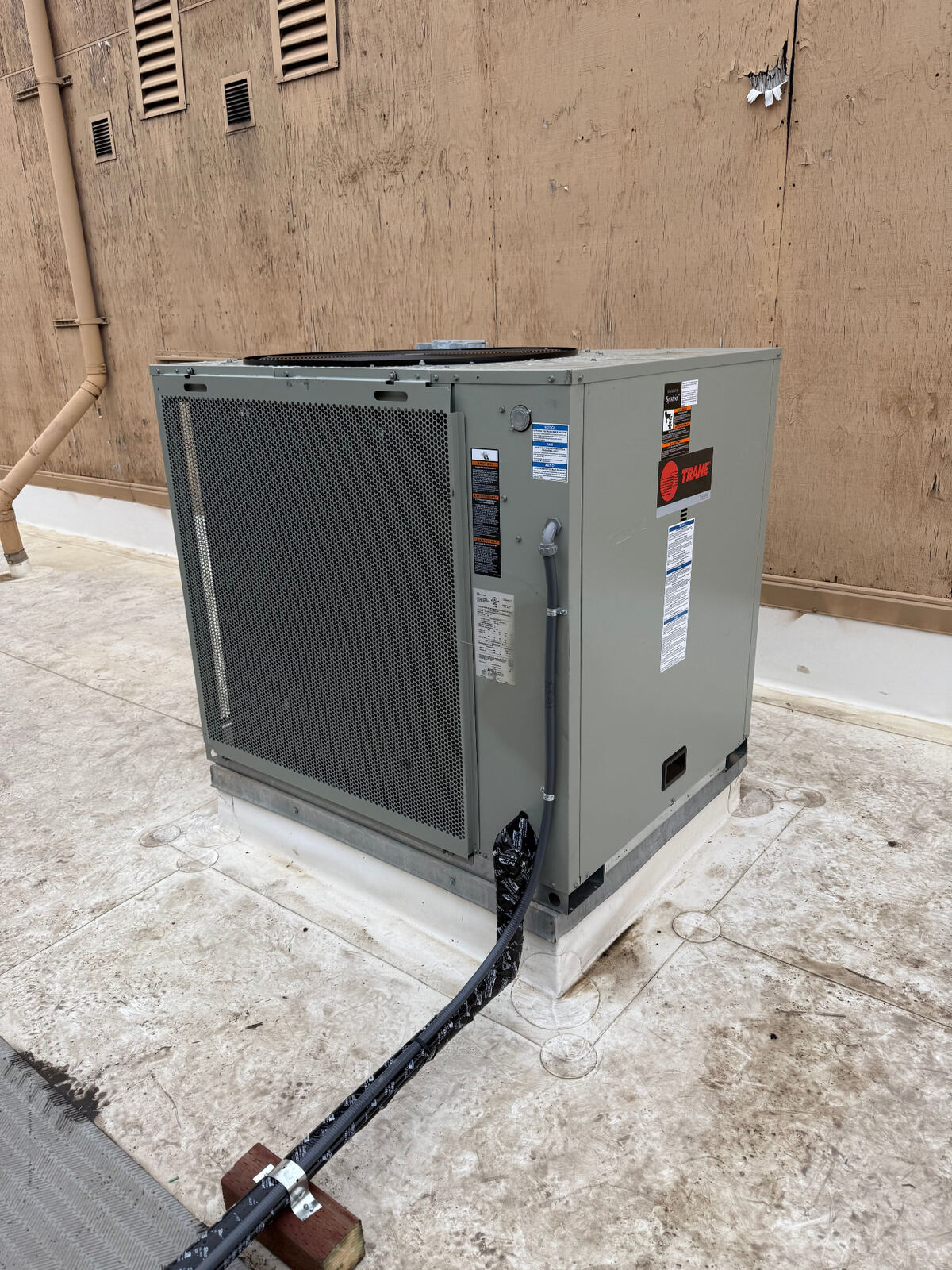 HVAC technician performing AC repair on outdoor unit
